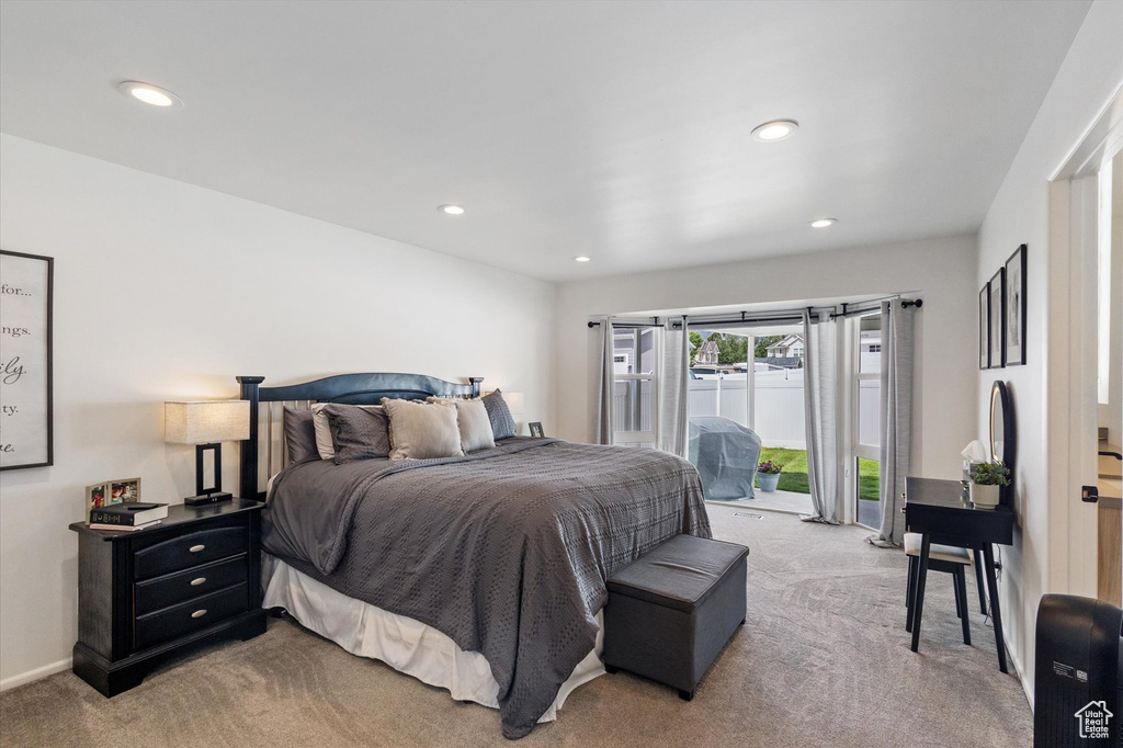 Bedroom with light colored carpet, access to exterior, and recessed lighting