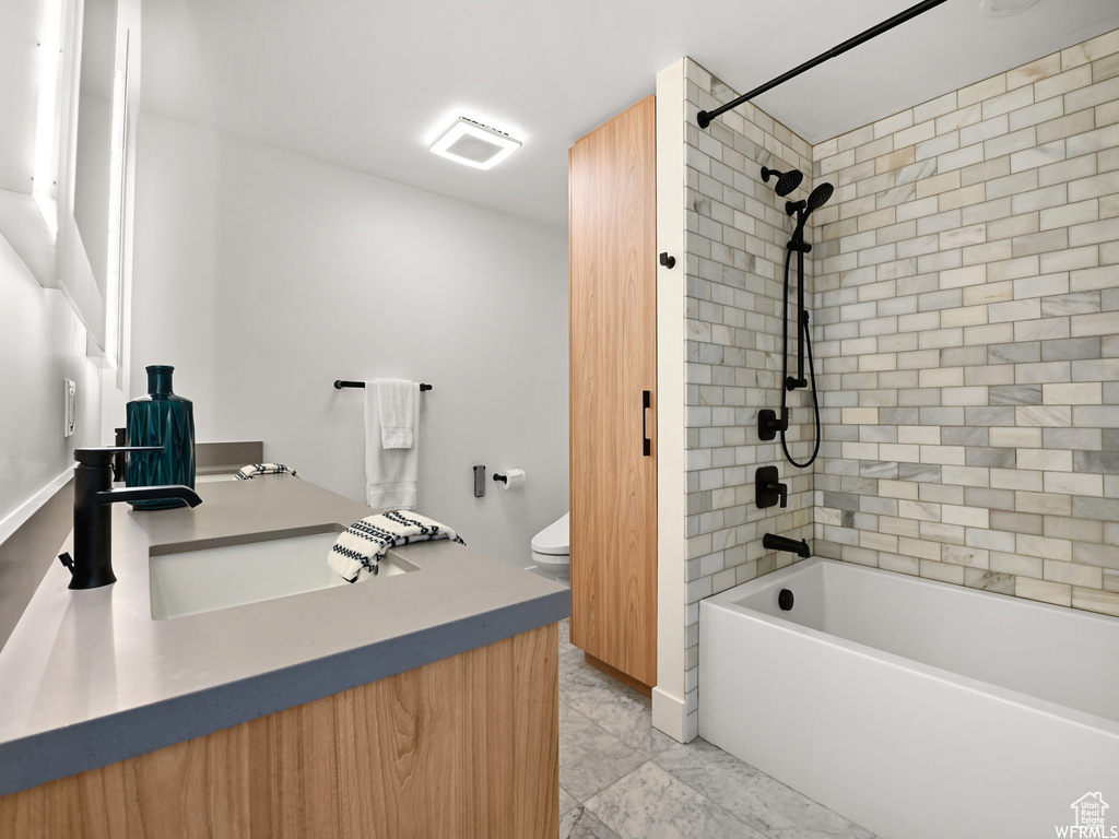 Full bathroom with toilet, vanity, and bathtub / shower combination