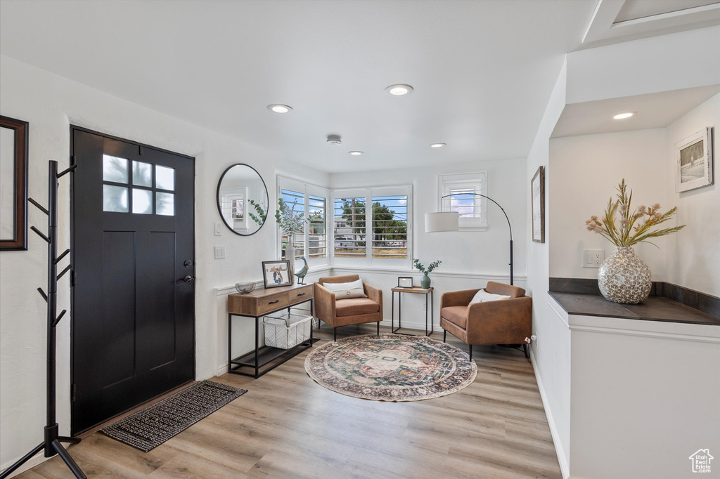 Foyer entrance featuring wood finished floors, baseboards, and recessed lighting