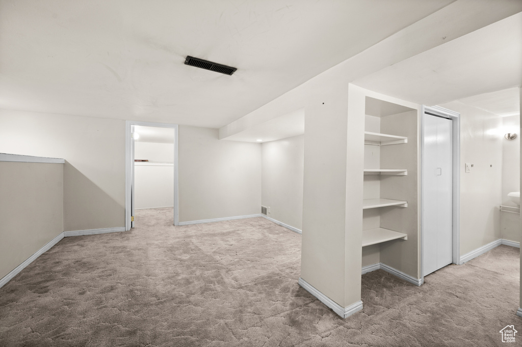 Finished below grade area with carpet flooring and baseboards