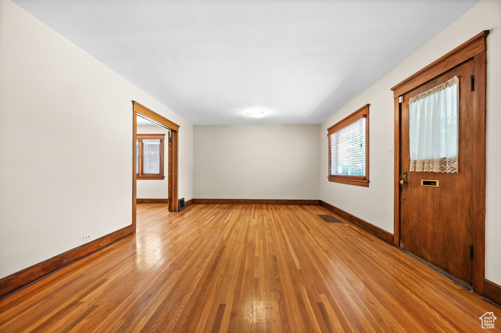 Unfurnished room with light wood-type flooring and baseboards