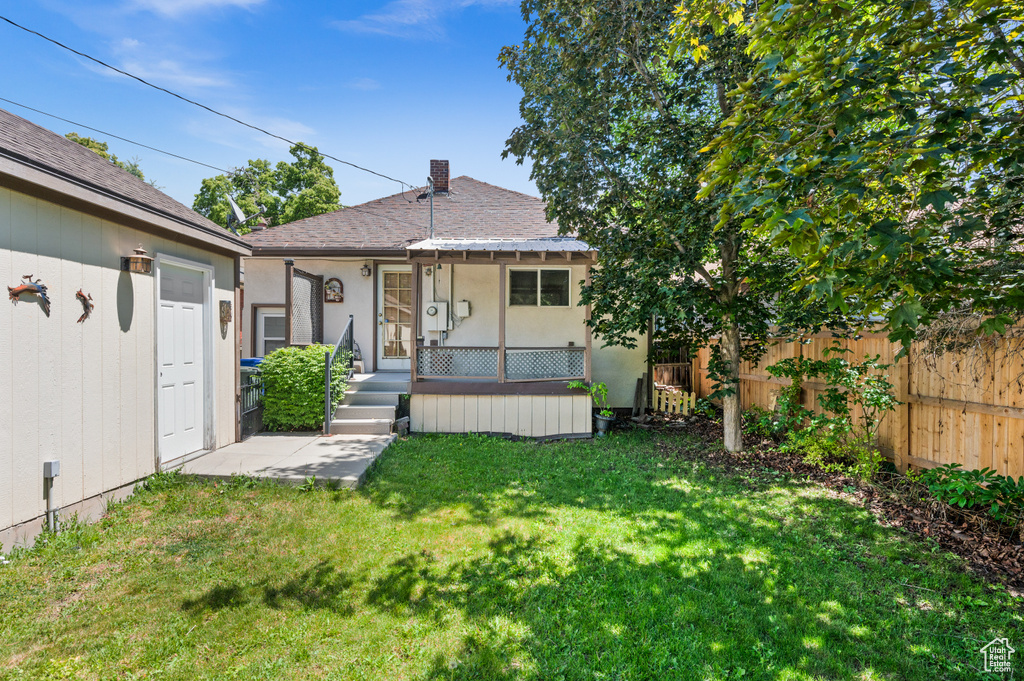 Rear view of property featuring stucco siding and roof with shingles