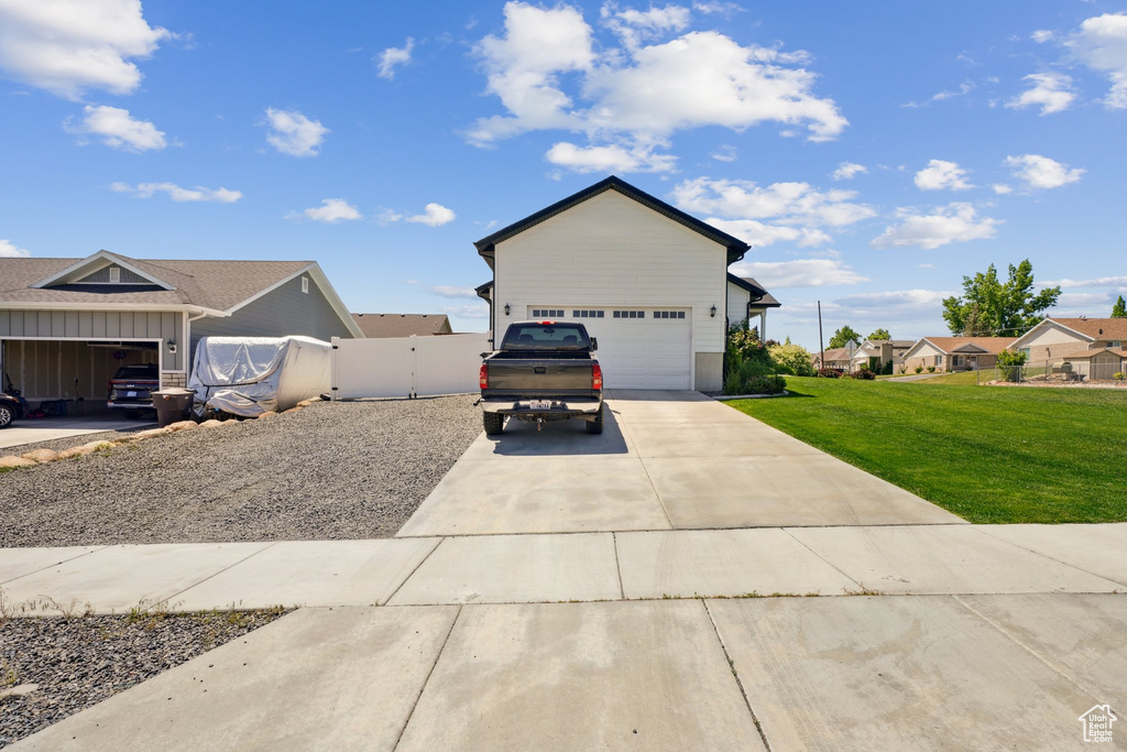 View of front of property featuring a garage, concrete driveway, and board and batten siding