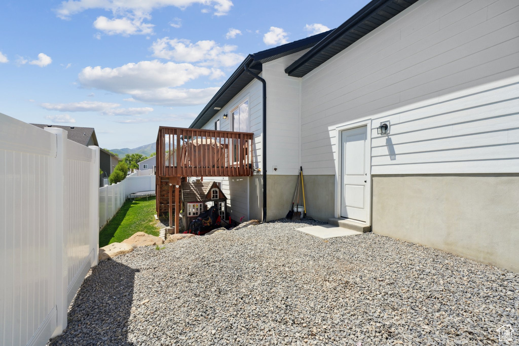 View of side of home with a deck