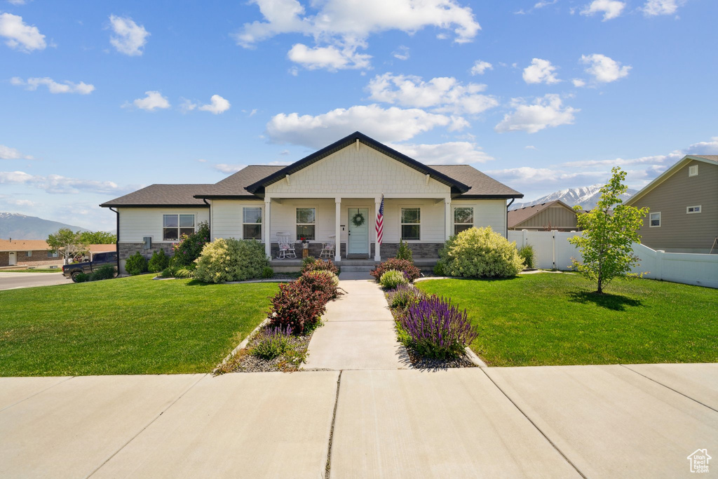 View of front of property featuring a porch, stone siding, and a mountain view