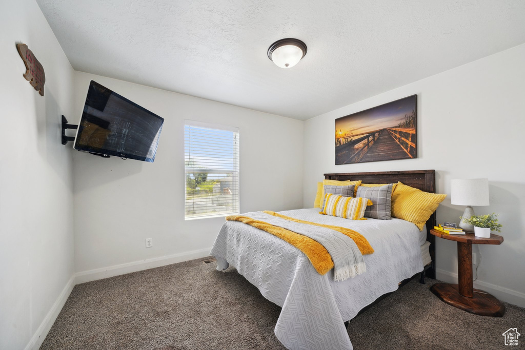 Bedroom featuring carpet flooring and baseboards