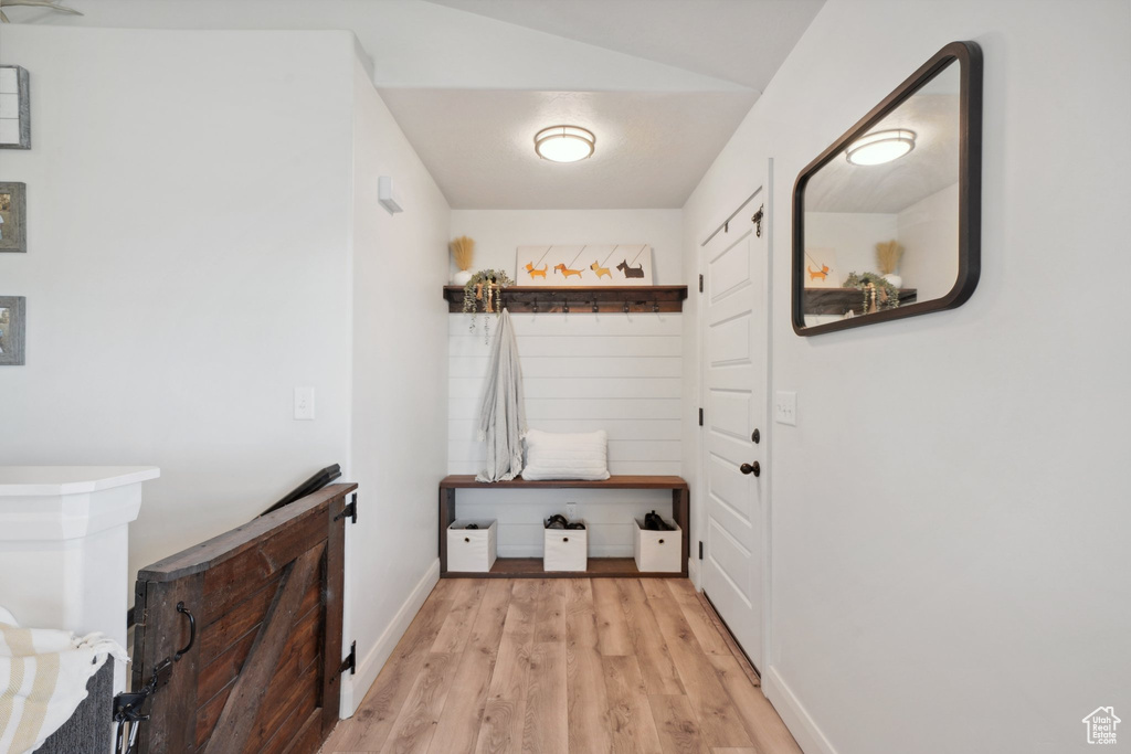 Mudroom with wood finished floors and baseboards