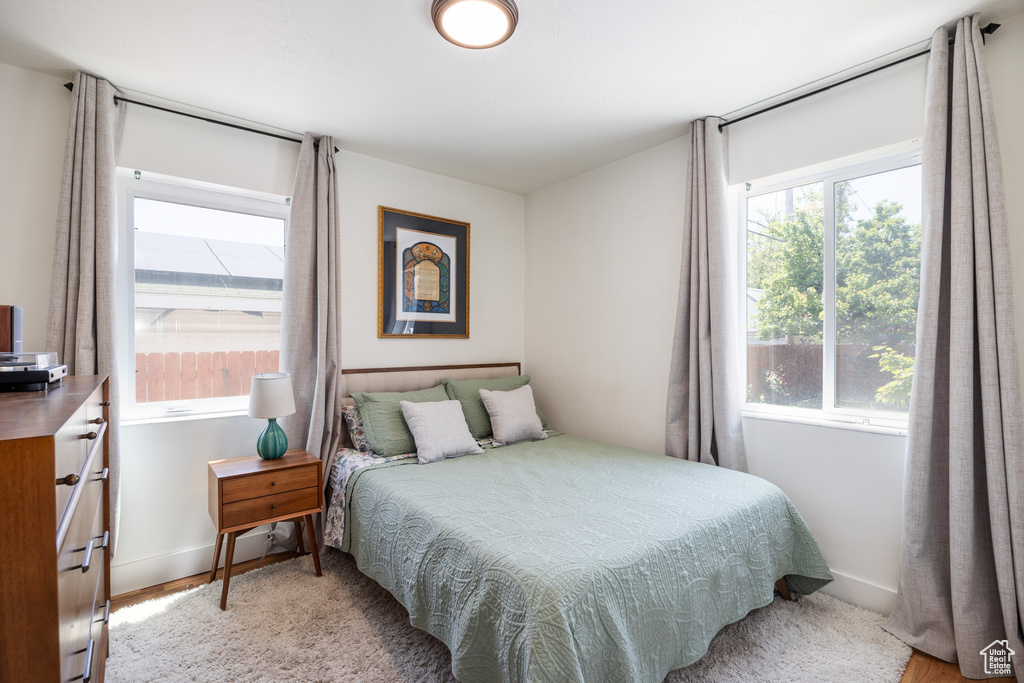 Bedroom with baseboards and light wood finished floors