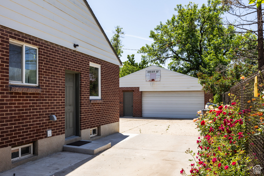 Detached garage featuring concrete driveway