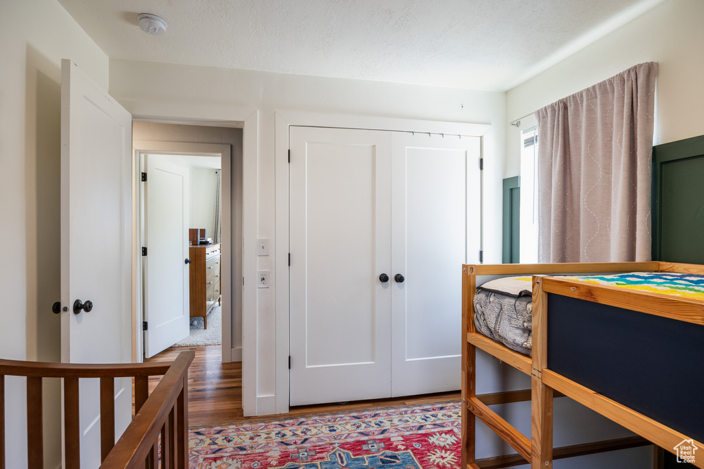 Bedroom featuring wood finished floors and a closet