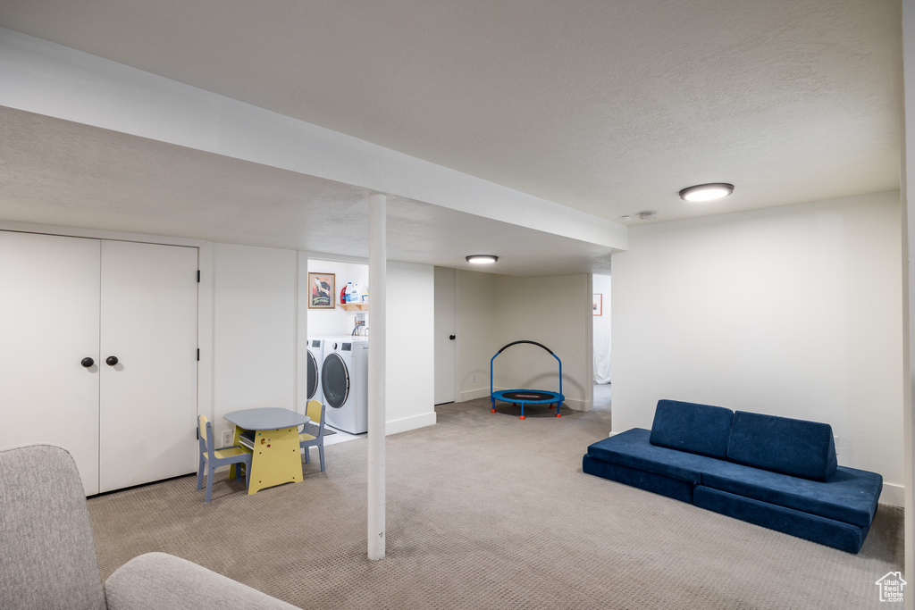 Finished basement featuring carpet flooring and separate washer and dryer