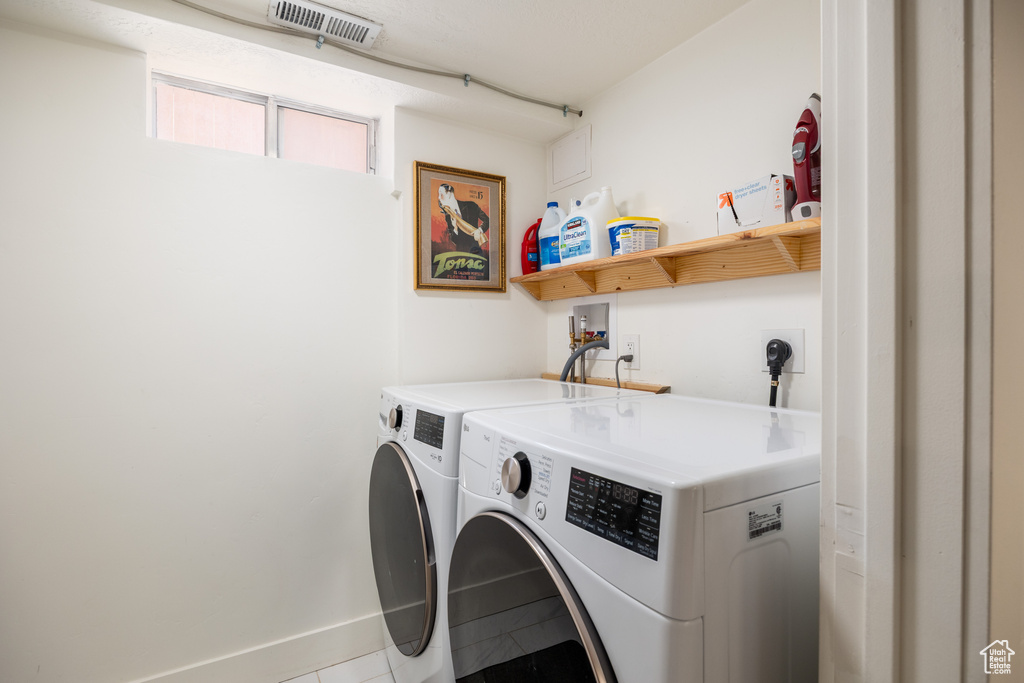 Washroom featuring washer and dryer