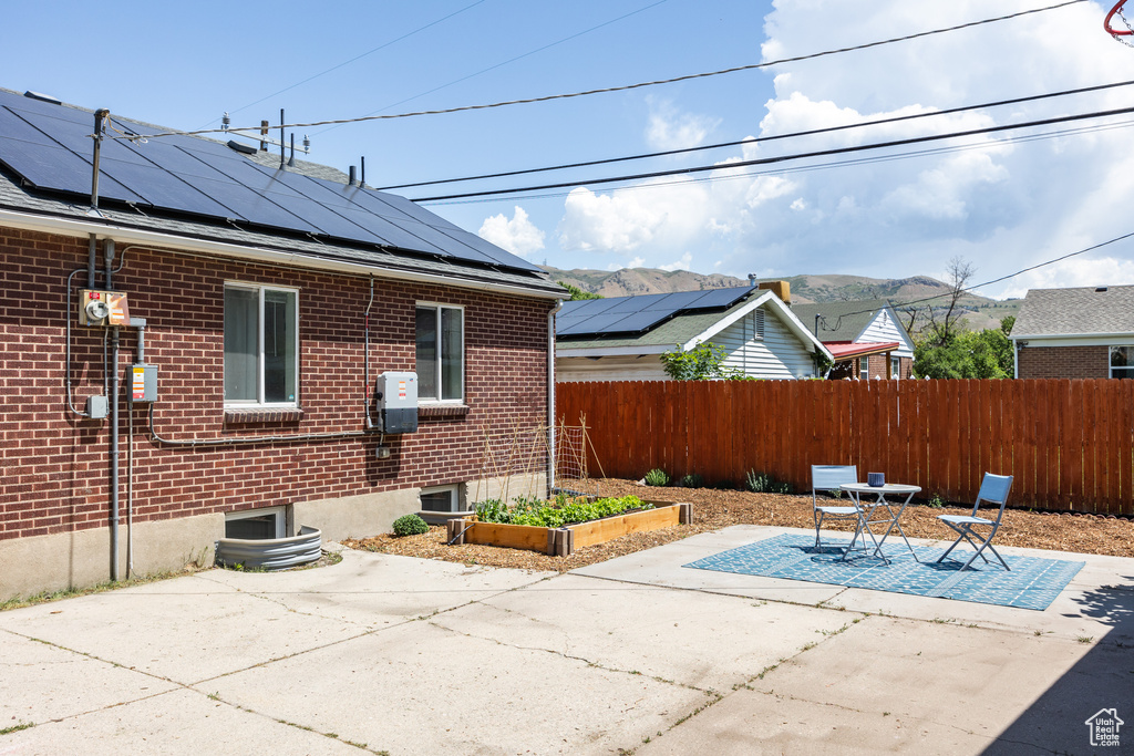 View of patio / terrace featuring a vegetable garden, outdoor dining space, and a mountain view
