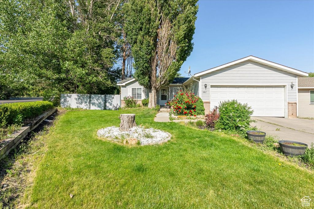 View of yard with driveway and an attached garage