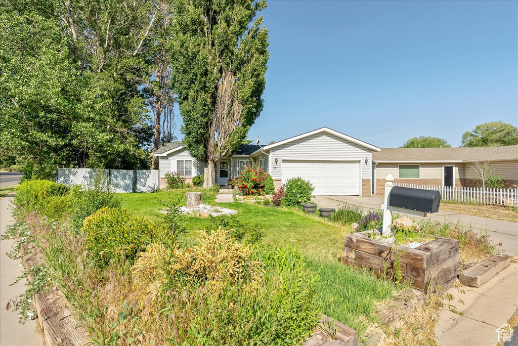 Ranch-style home with driveway and an attached garage