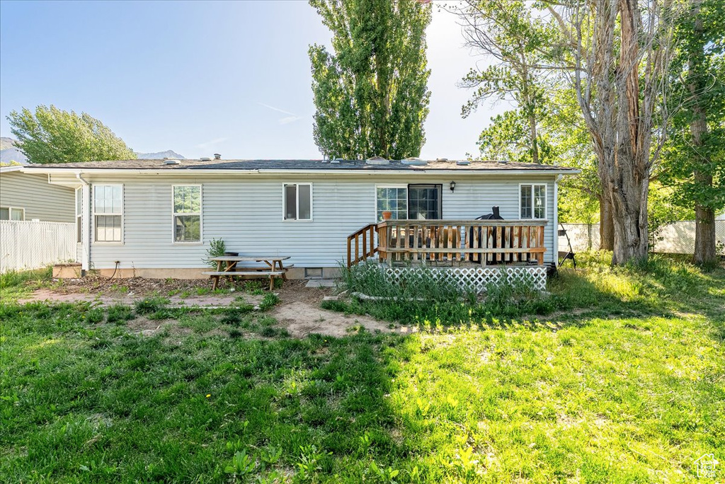 Back of property with a wooden deck