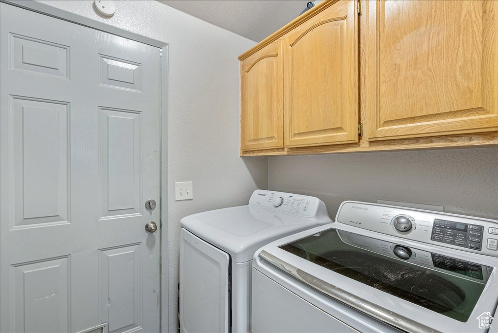 Laundry area with separate washer and dryer and cabinet space