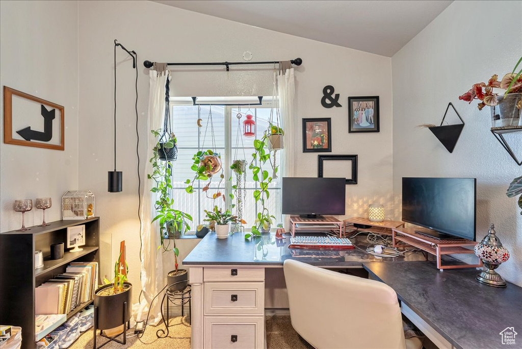 Office area featuring vaulted ceiling