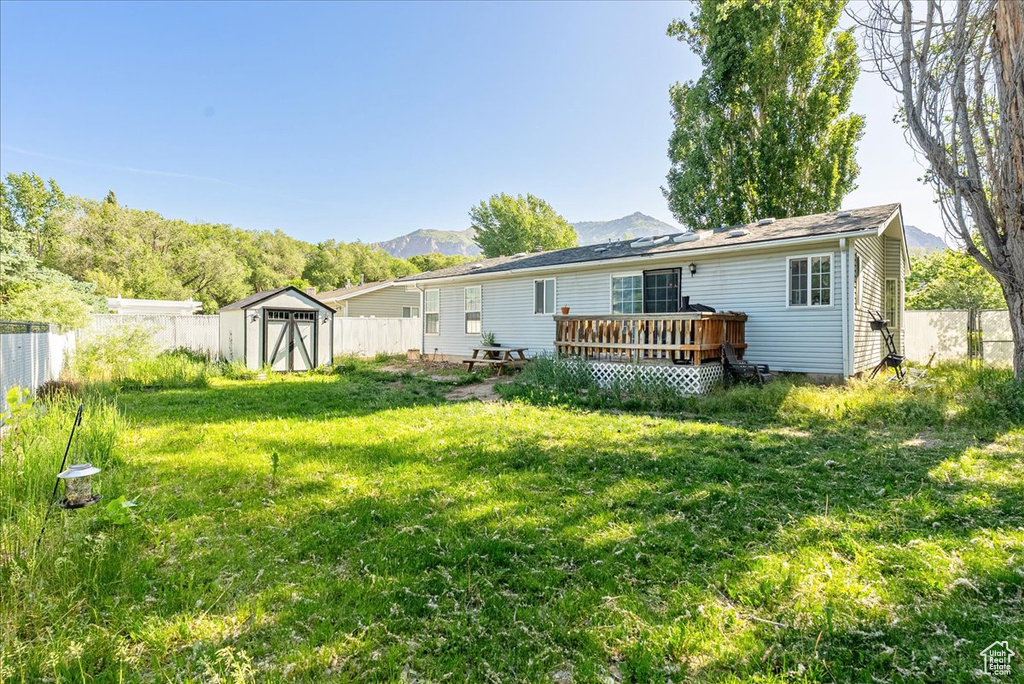 Rear view of house featuring a deck with mountain view