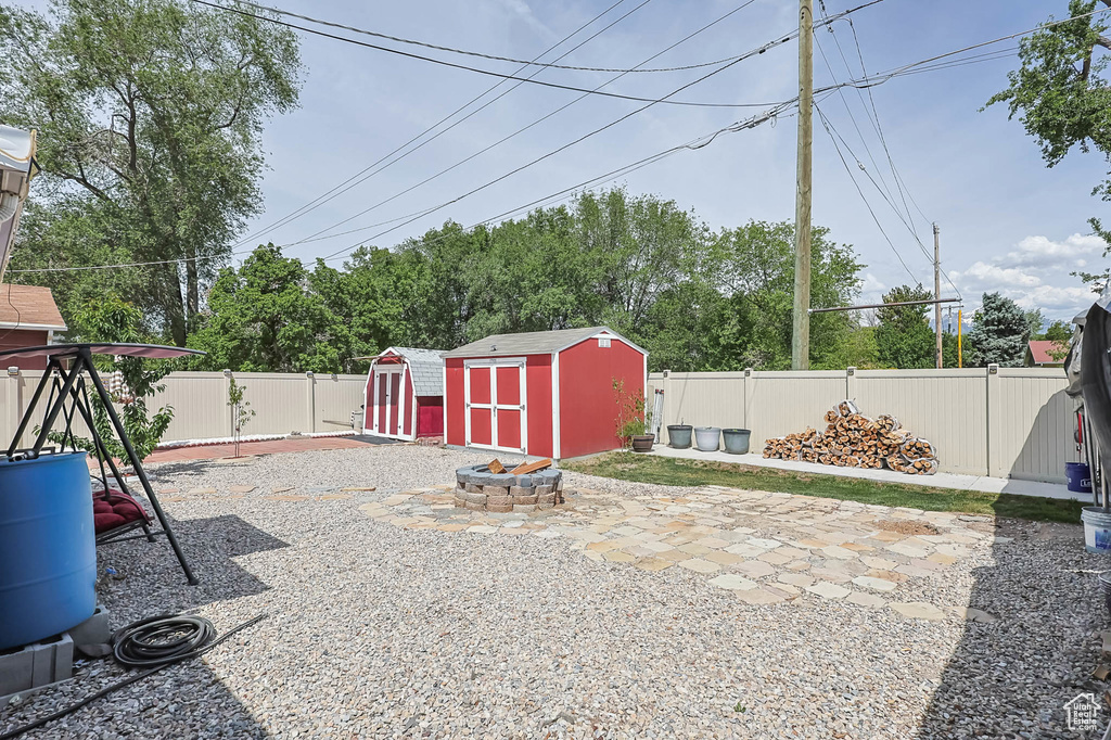 Fenced backyard featuring a patio and a fire pit