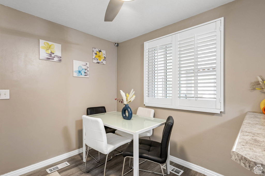 Dining area featuring baseboards, wood finished floors, and a ceiling fan