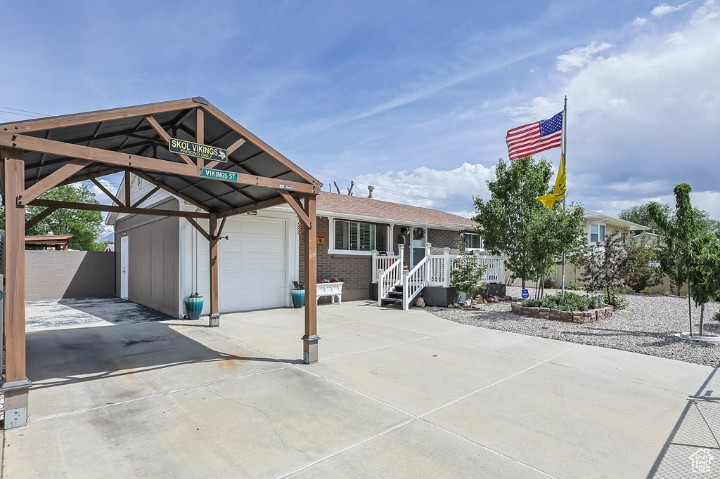View of front of house featuring driveway, a garage, and brick siding