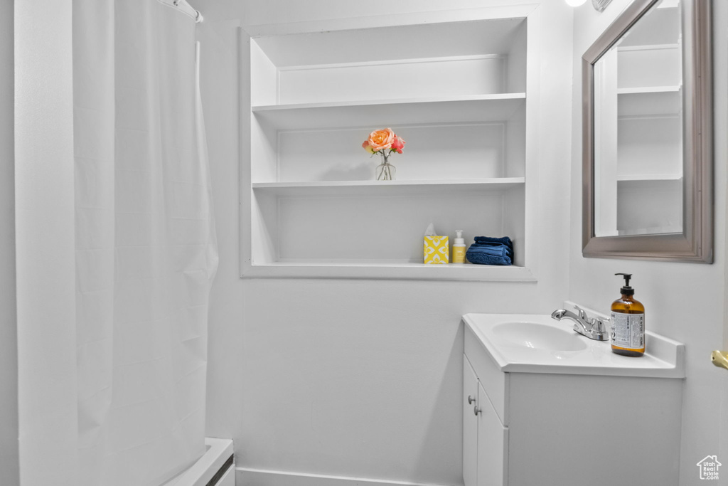 Bathroom featuring vanity and a shower with shower curtain