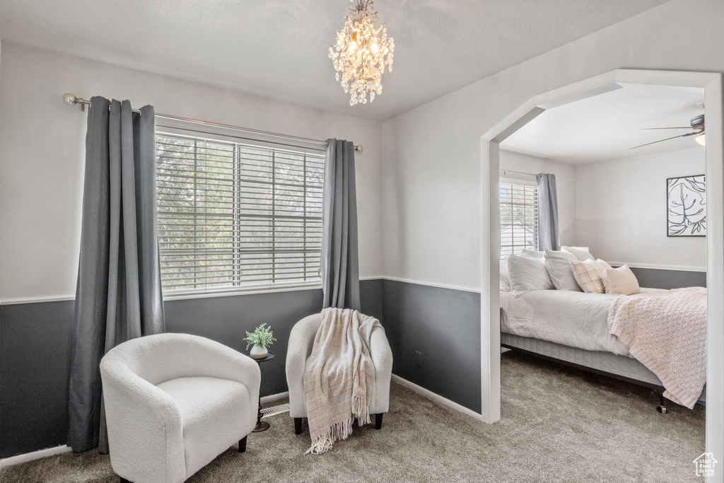 Bedroom featuring arched walkways, carpet floors, a chandelier, and baseboards