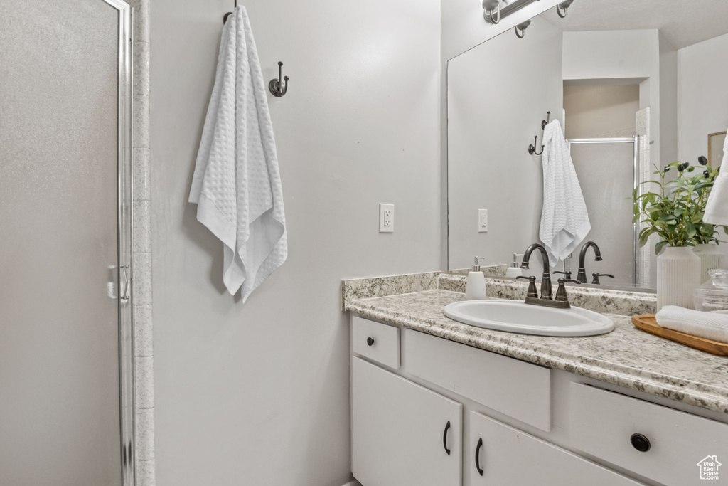 Bathroom featuring vanity and a shower stall