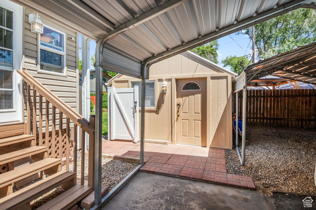 View of shed featuring a fenced backyard and a detached carport