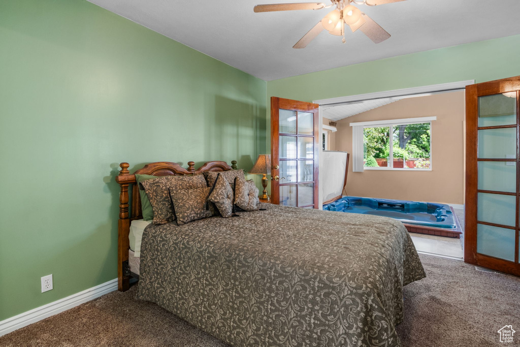 Bedroom featuring carpet flooring, vaulted ceiling, baseboards, and a ceiling fan