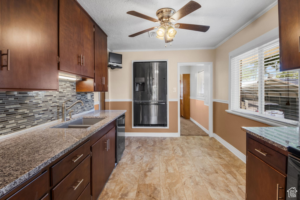 Kitchen featuring a sink, refrigerator with ice dispenser, black dishwasher, decorative backsplash, and ceiling fan