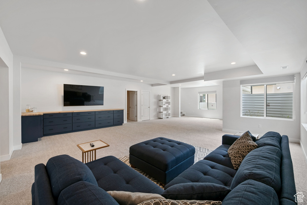 Living room featuring light colored carpet, recessed lighting, and baseboards