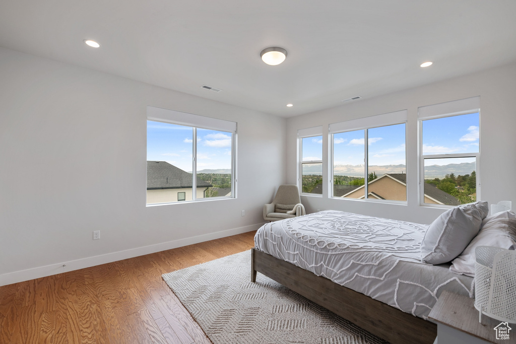 Bedroom featuring baseboards, wood finished floors, and recessed lighting