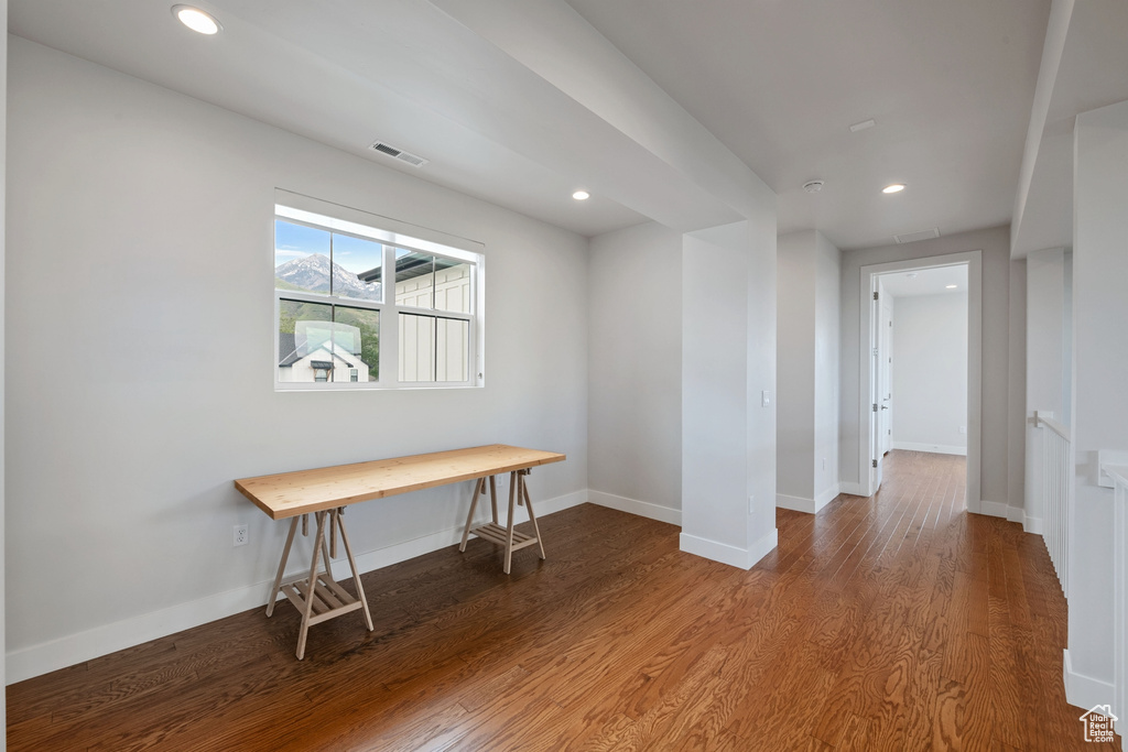 Spare room with wood finished floors, baseboards, and recessed lighting
