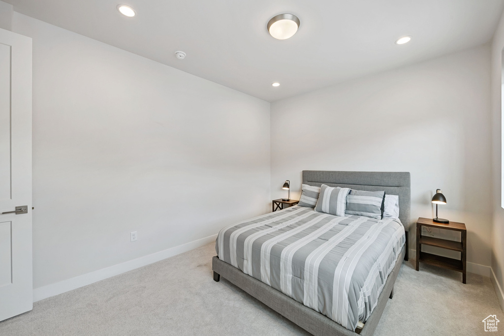 Carpeted bedroom with recessed lighting and baseboards