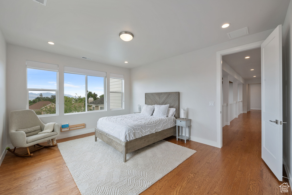 Bedroom featuring baseboards, wood finished floors, and recessed lighting
