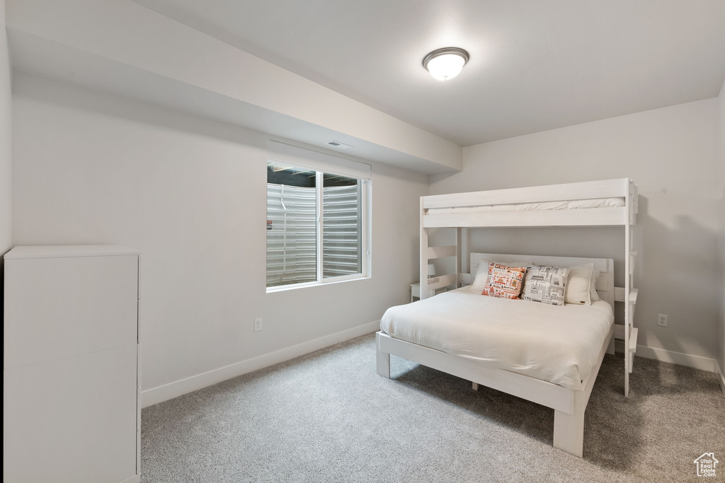 Bedroom with carpet floors and baseboards