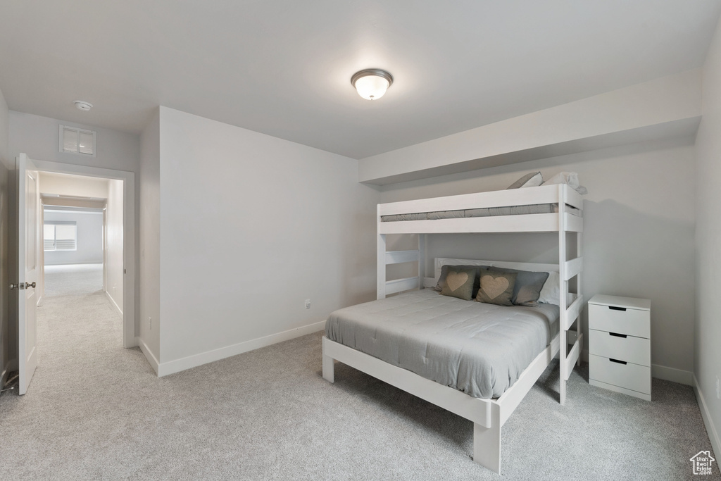 Carpeted bedroom featuring baseboards