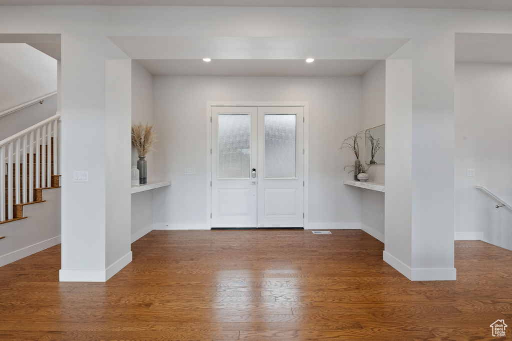 Entrance foyer with wood finished floors, baseboards, and recessed lighting