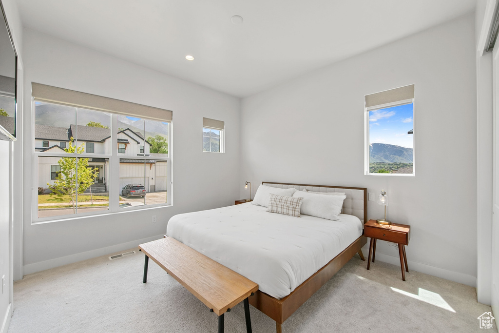 Carpeted bedroom with baseboards and recessed lighting