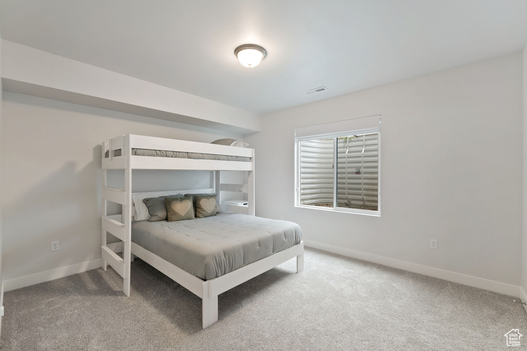 Carpeted bedroom with baseboards