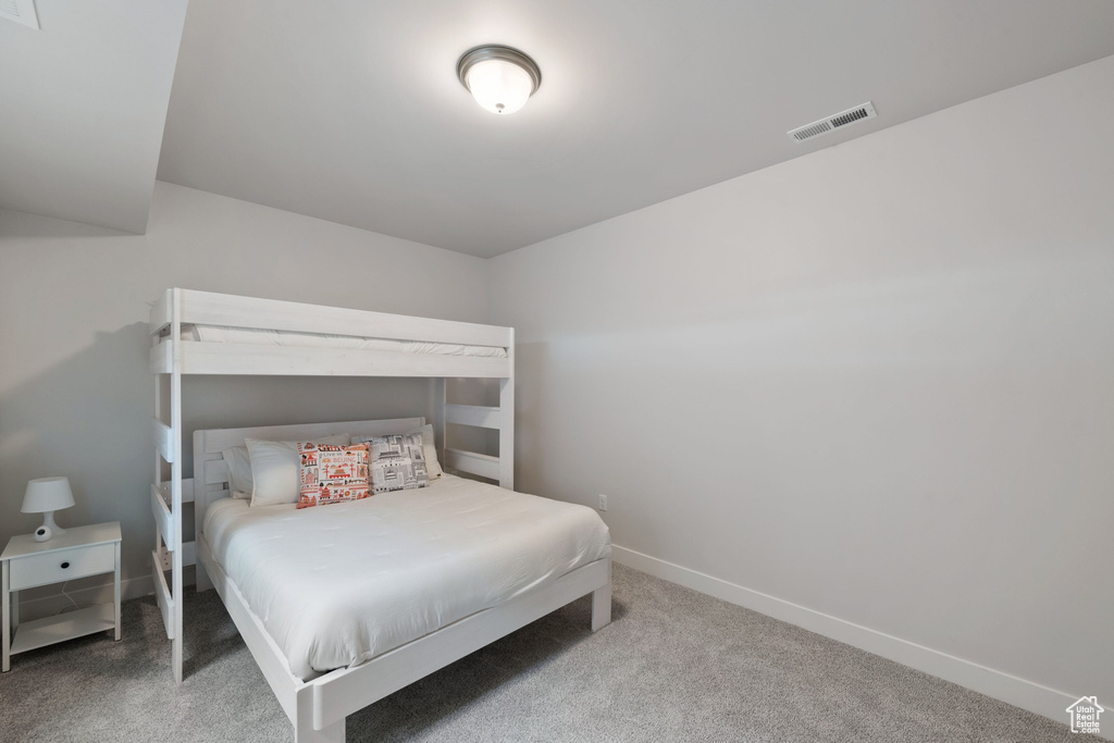 Bedroom with carpet floors and baseboards
