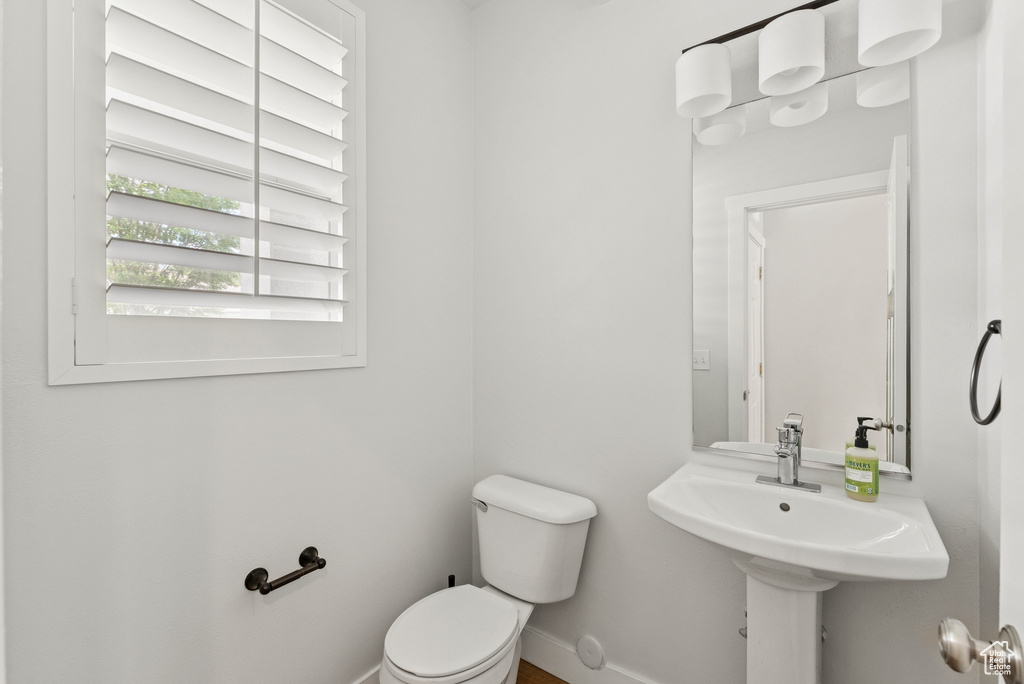 Half bathroom featuring toilet and baseboards