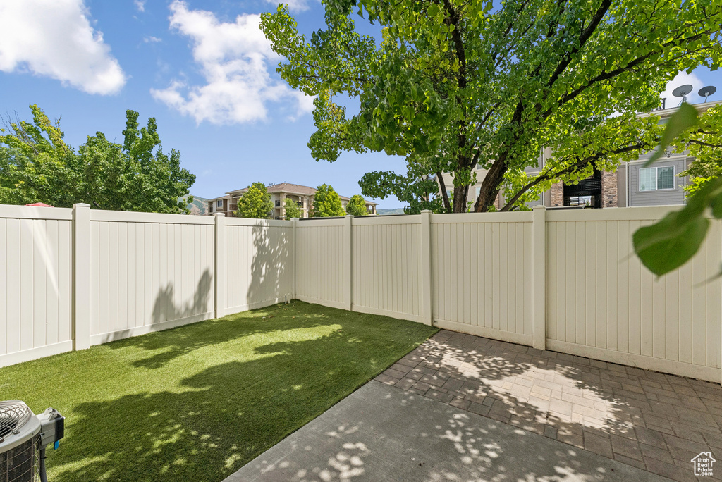 Fenced backyard with a patio