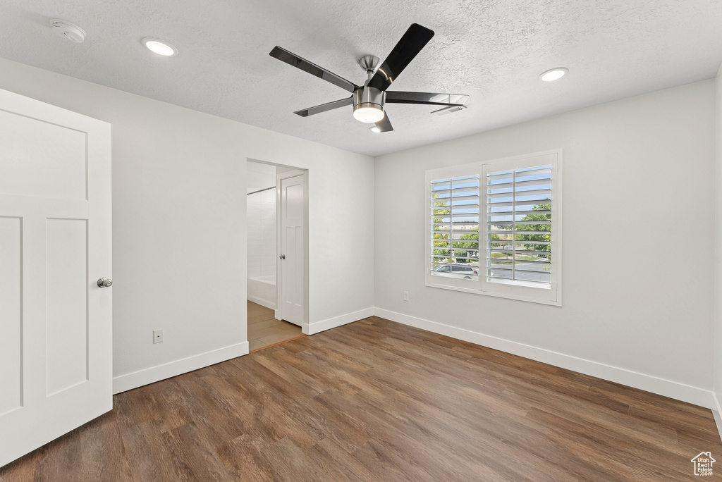 Unfurnished bedroom featuring wood finished floors, a textured ceiling, recessed lighting, and a ceiling fan