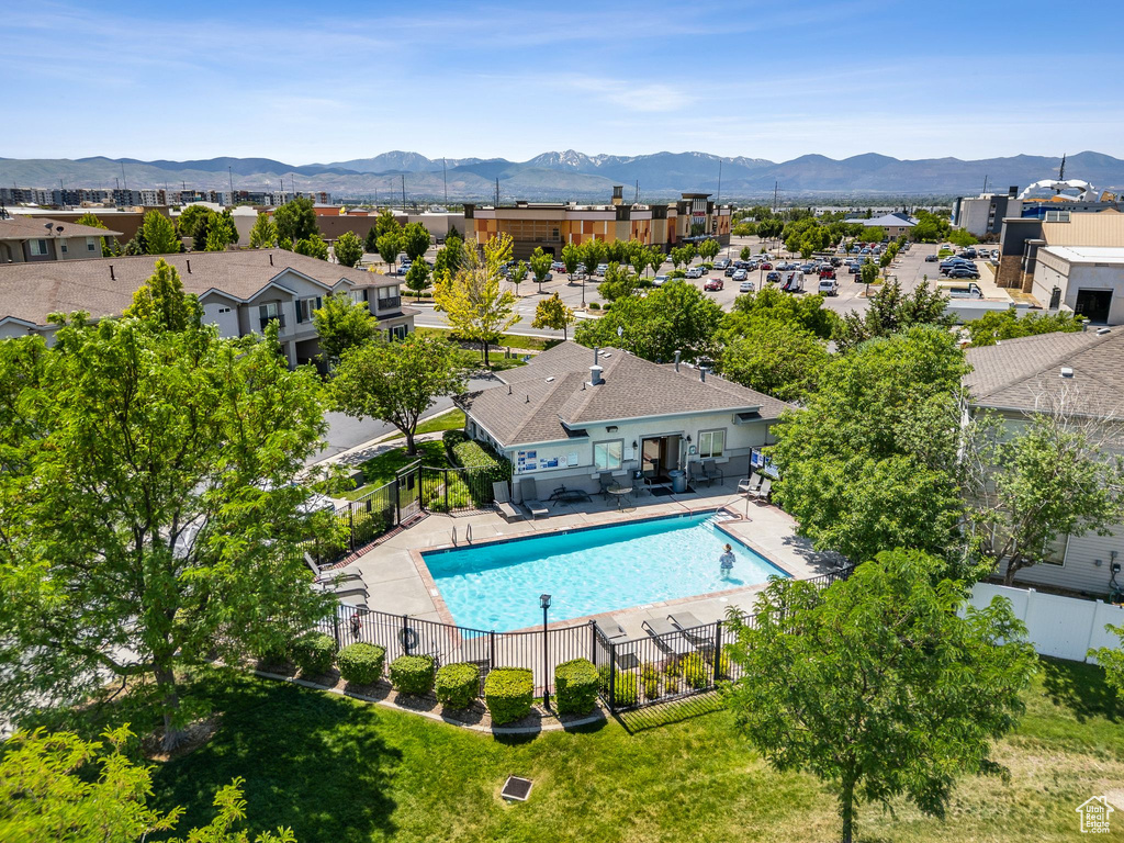 Community pool featuring a mountain view and a patio area