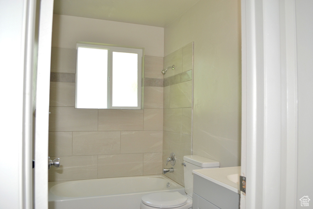 Full bath featuring toilet, vanity, and shower / bath combination