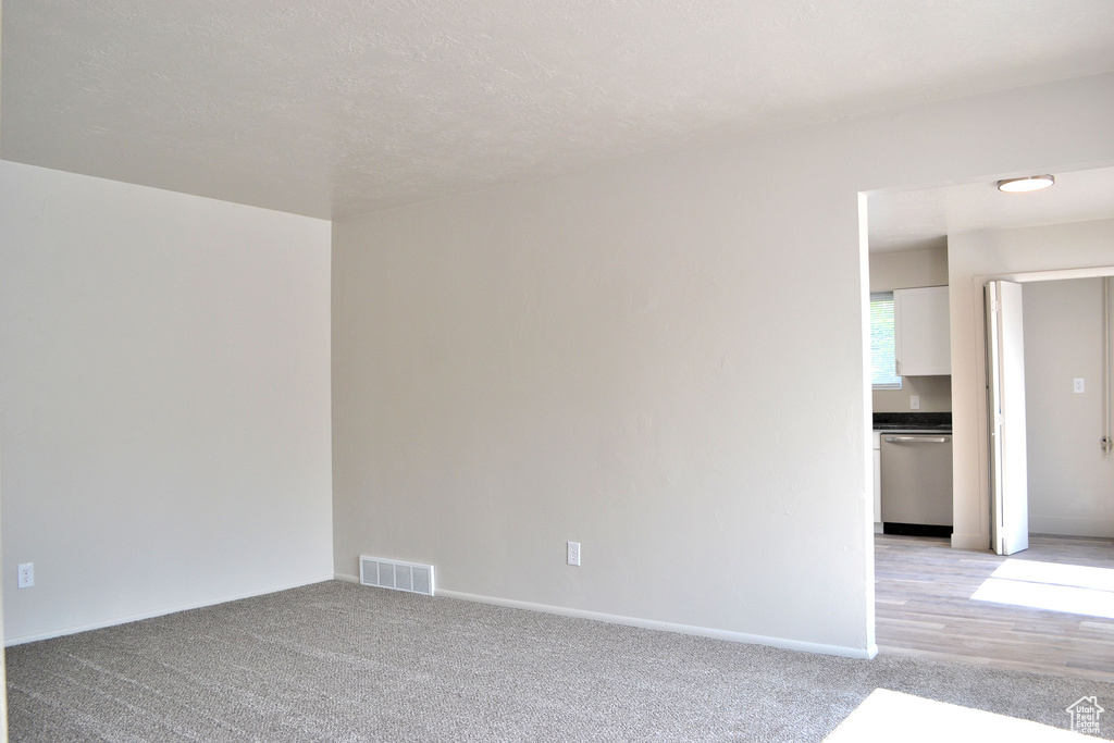Unfurnished room with light carpet and baseboards