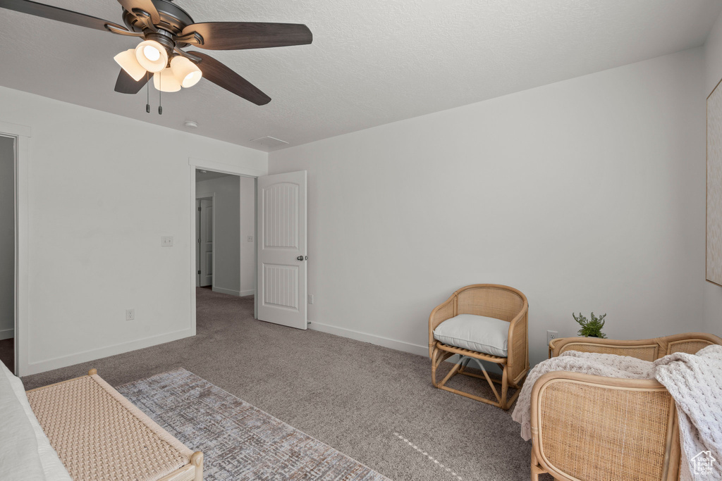 Carpeted bedroom featuring baseboards and a ceiling fan
